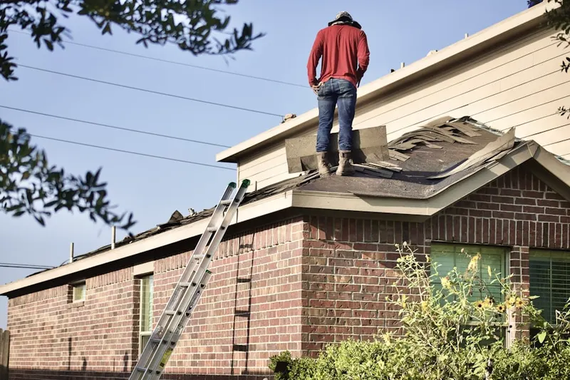 Professional roofer working on a residential roof in Berthoud